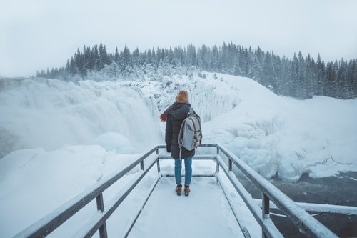woman traveling in winter with backpack