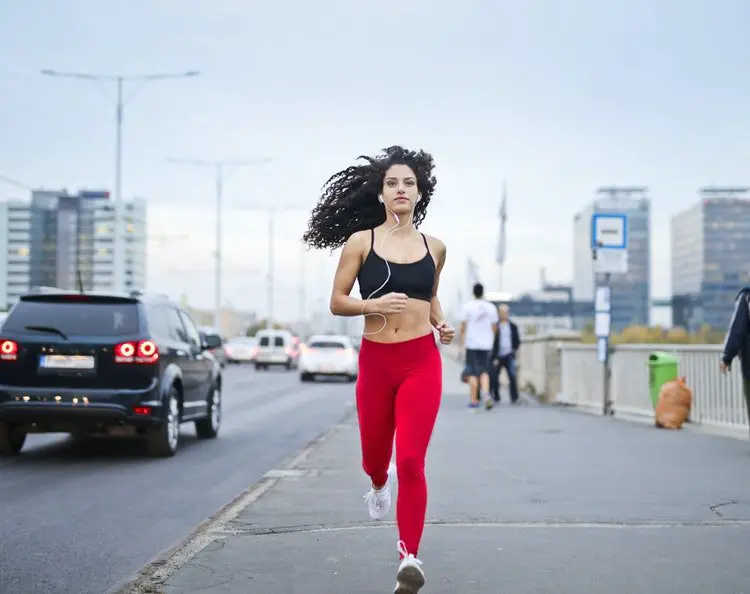 Woman jogging while listening to music