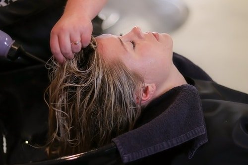 woman getting hair shampooed