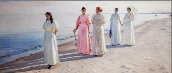 women on the beach long clothing and umbrellas