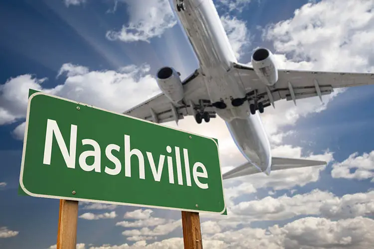 Nashville Green Road Sign and Airplane Above